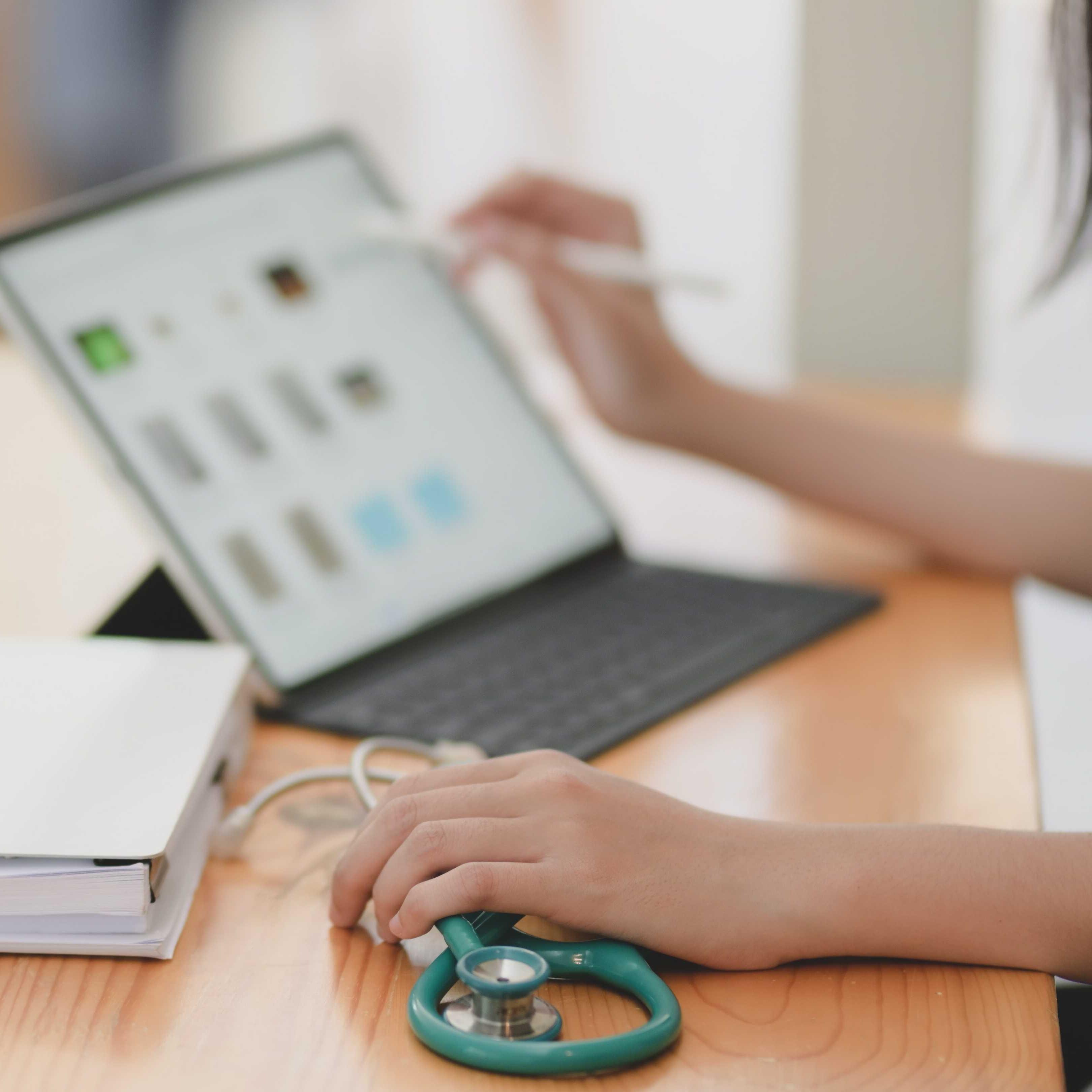 A health care worker using a laptop